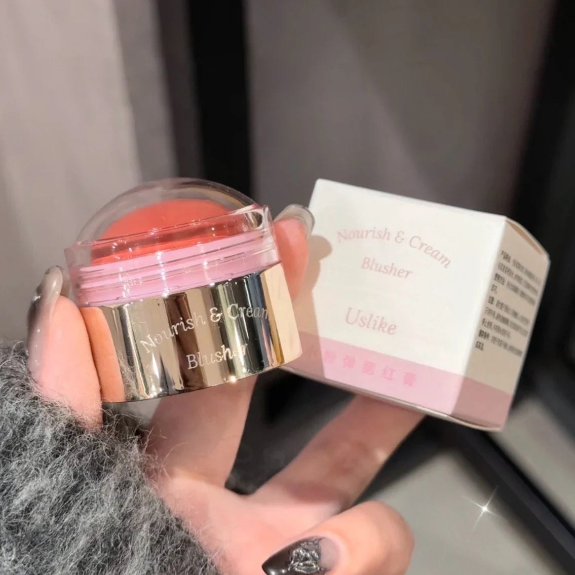 Blushimmer creamy purple blush stick with peach pink tint, showing smooth, blendable face makeup for brightening and contouring.