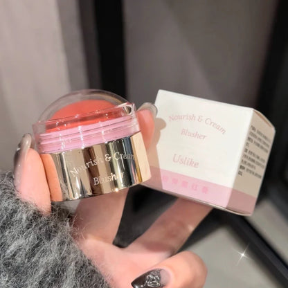 Blushimmer creamy purple blush stick with peach pink tint, showing smooth, blendable face makeup for brightening and contouring.
