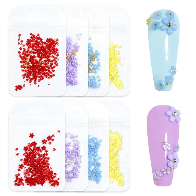 White acrylic flower nail art decorations with mixed size red and blue rhinestones for DIY manicure designs by Blushimmer.