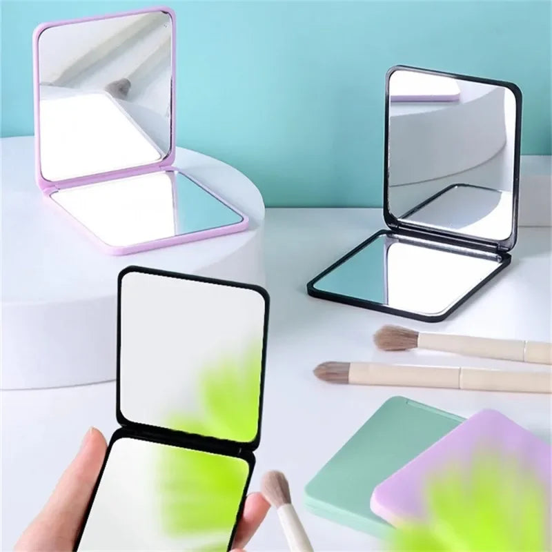 Blushimmer foldable double-sided portable makeup mirror on a desk, compact and ideal for students or dorm use