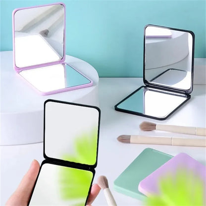Blushimmer foldable double-sided portable makeup mirror on a desk, compact and ideal for students or dorm use