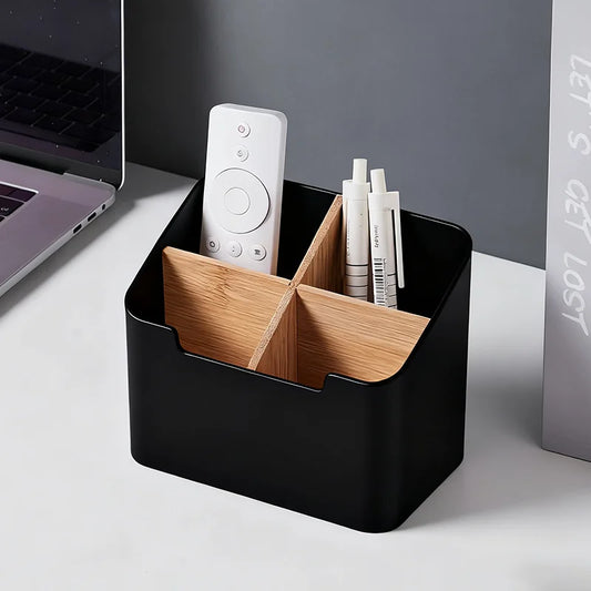 Blushimmer remote control holder and organizer with compartments for TV remotes, makeup brushes, and office supplies on a desktop.