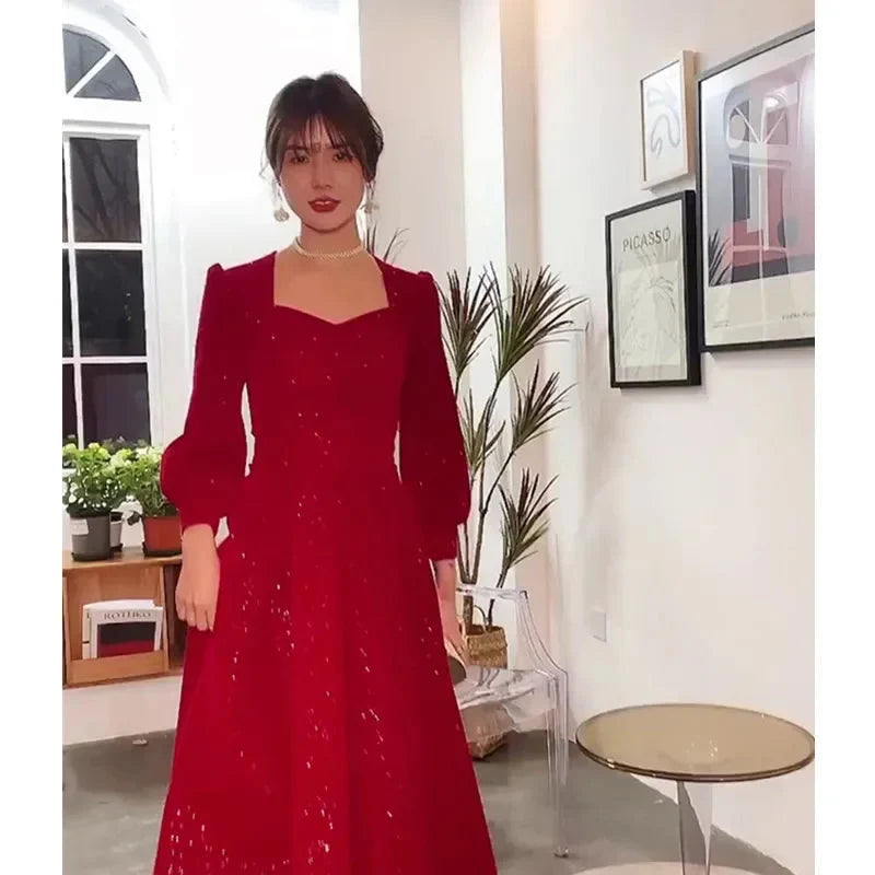 Elegant red luxury ceremony gown by Luxlife Brands featuring intricate detailing and flowing fabric for special occasions.