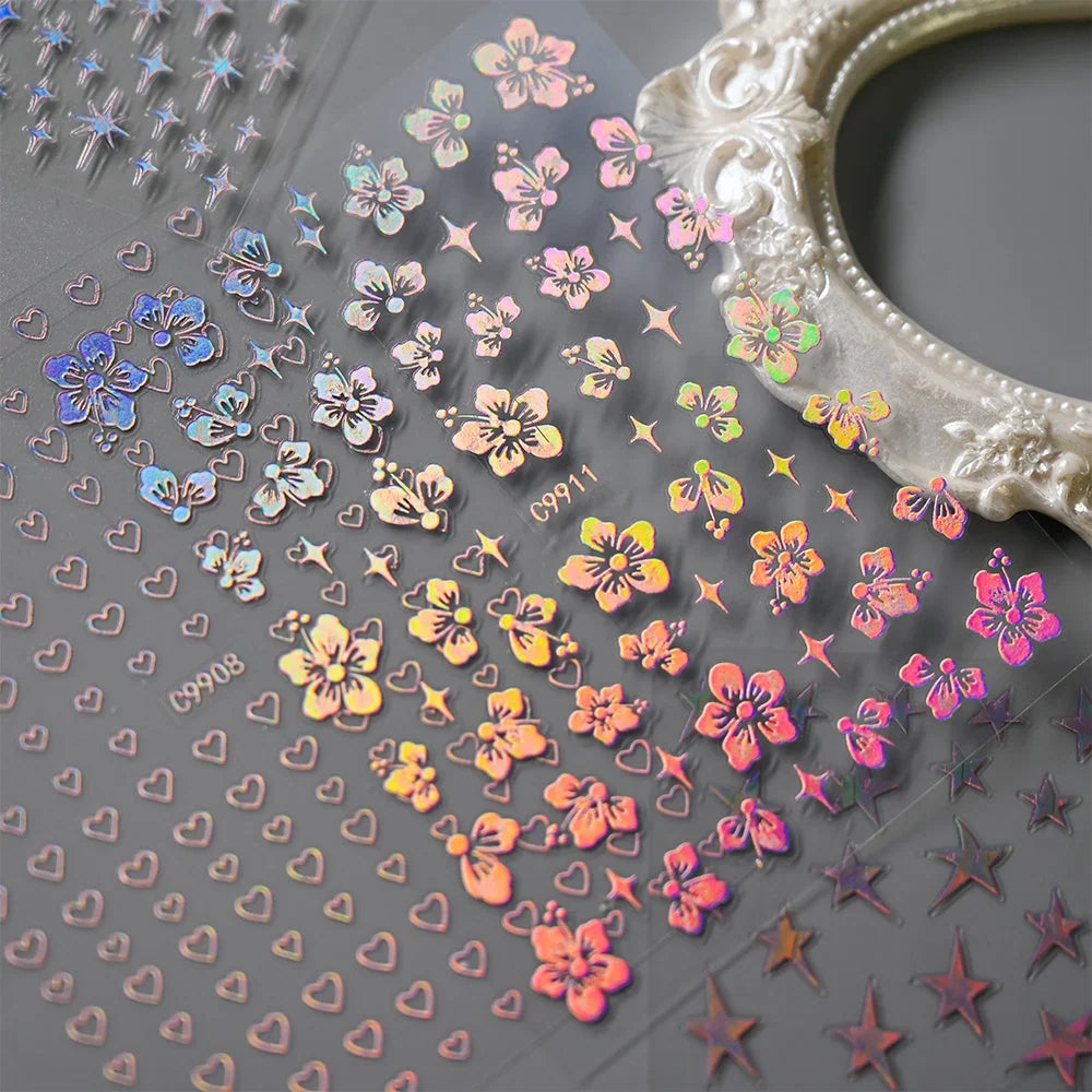 12pcs Blushimmer bronzing laser star nail stickers featuring 3D alphabet, heart, flower designs for DIY gradient manicure.