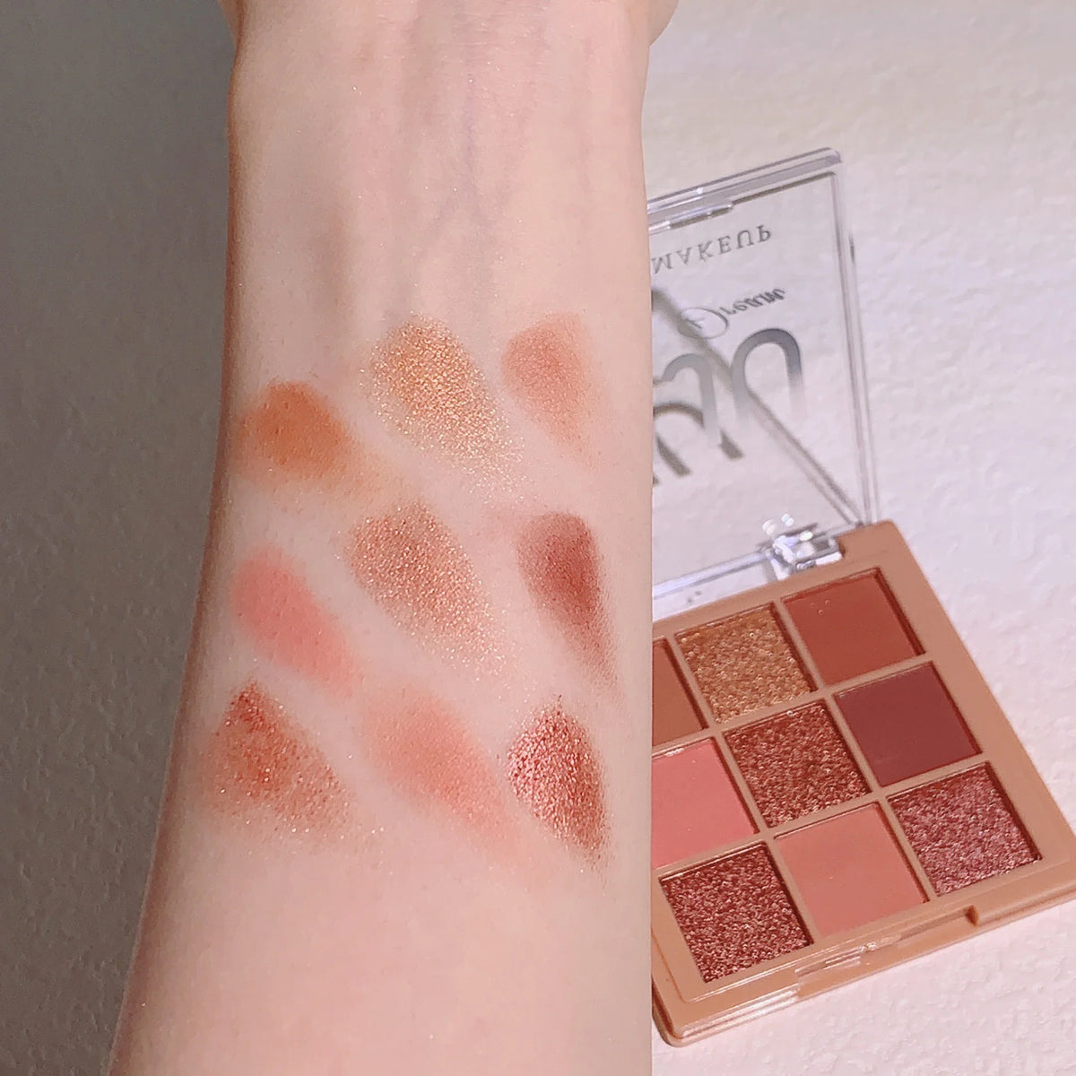 Blushimmer warm winter eyeshadow palette with nine earth tone shades including orange, brown, and milk tea colors in a low saturation palette.
