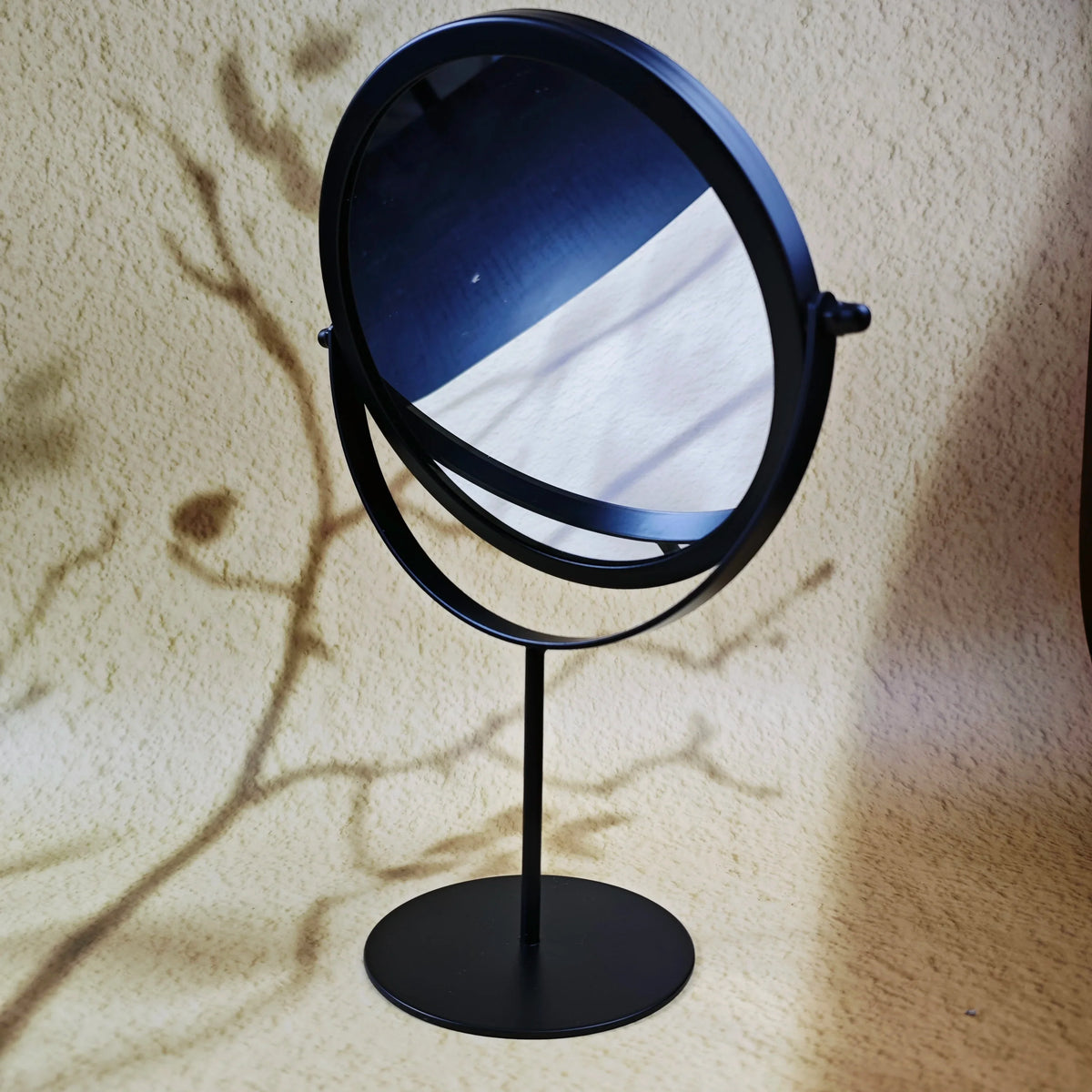 Blushimmer 360° rotate iron desktop makeup mirror with textured design, stylish and durable for ladies' beauty routines.