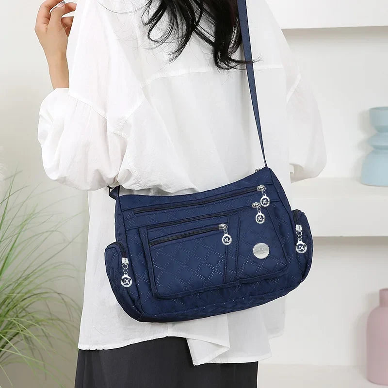 Blue OBA ladies crossbody handbag with sleek design, compact size, and adjustable strap, perfect for travel and everyday use.