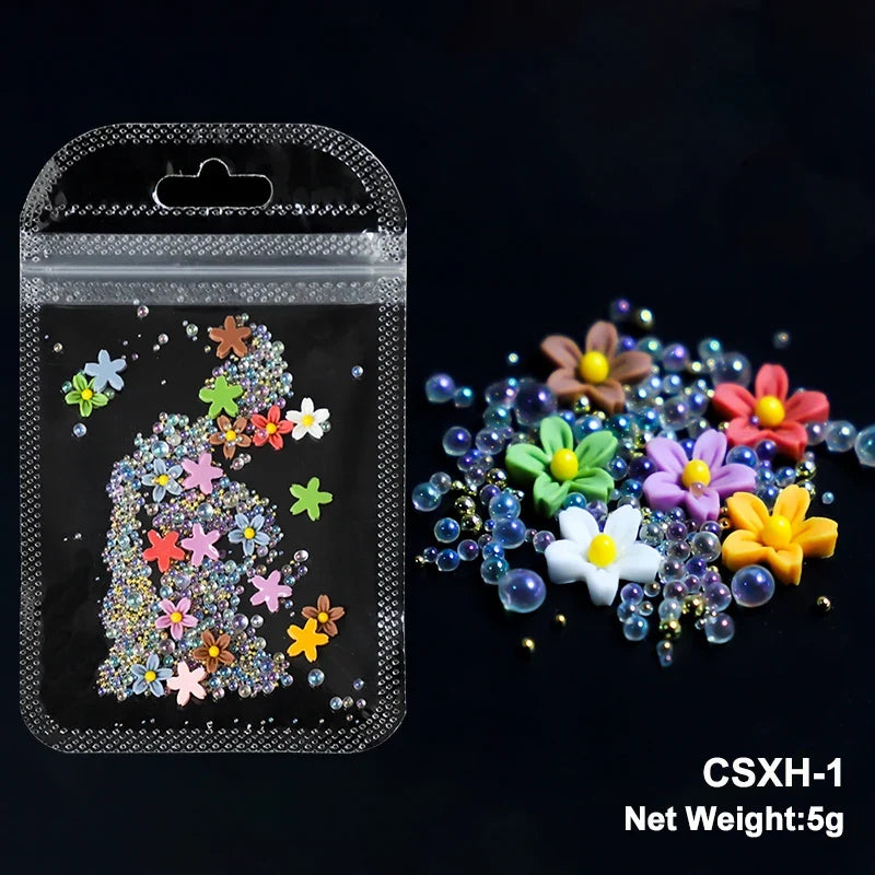 White acrylic flower nail art decorations with mixed size rhinestones and colorful gems for manicure DIY nails by Blushimmer.