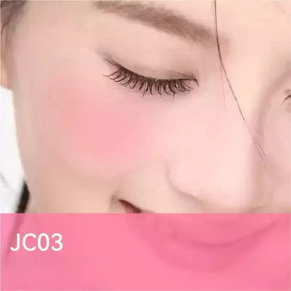 Blushimmer AZTK liquid blush in purple, with a matte finish, brightening and lifting the complexion on a woman's cheek.