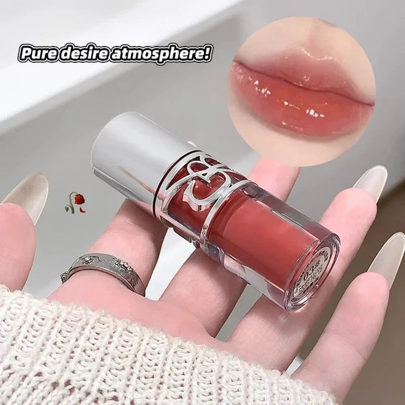 Blushimmer clear glass shine lip gloss with watery, moisturizing, and plumping formula in a sleek applicator tube.