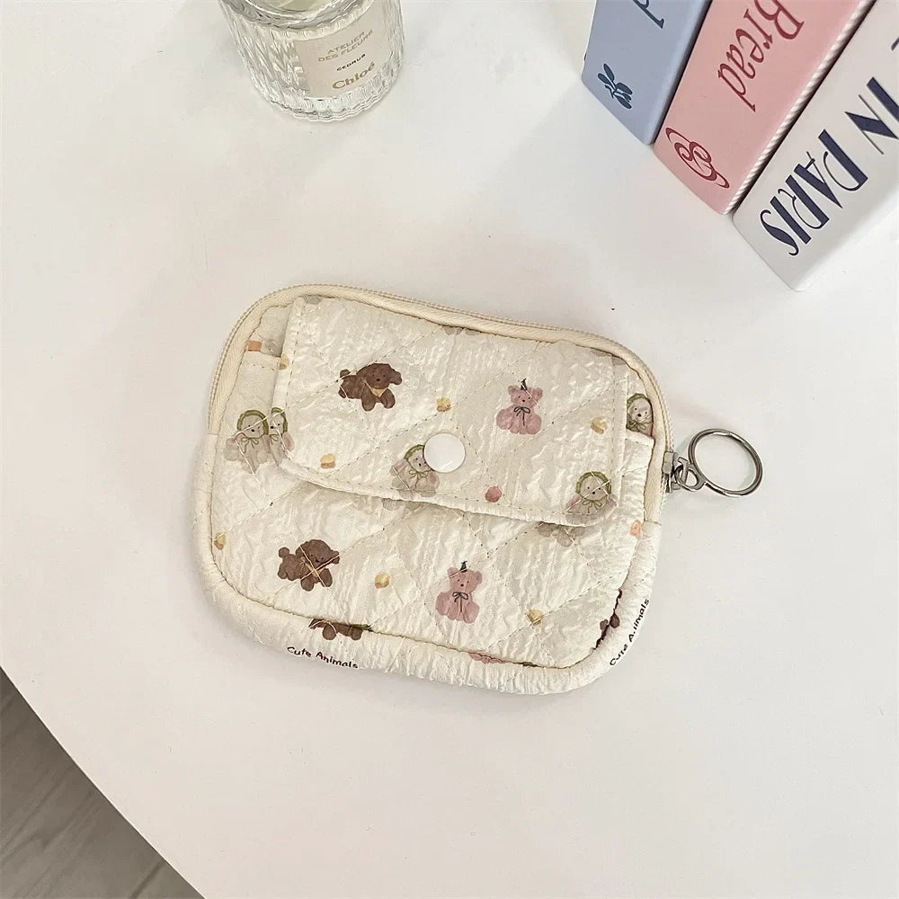 Blushimmer cute cartoon small travel cosmetic bag with lipstick, earphone, card slots, and zipper pocket for women’s makeup and accessories.