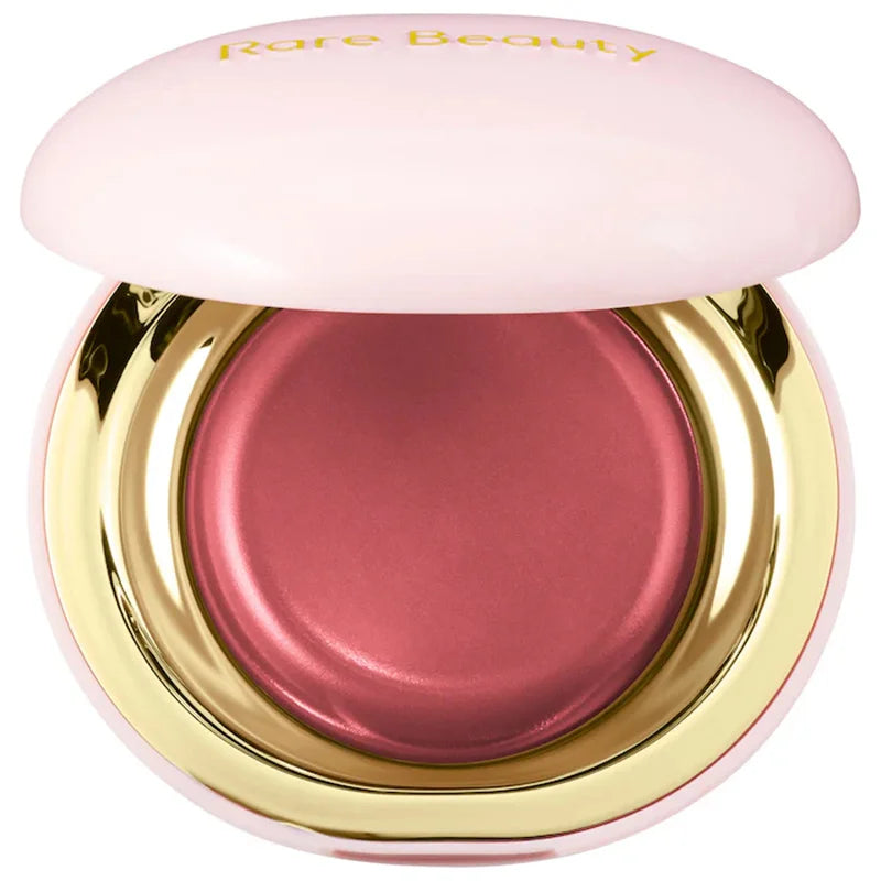 Blushimmer Rare Beauty melting cream blush with pearlescent finish, glitter highlights, and nourishing lip gloss in a sleek makeup container