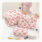 Cute quilted cotton makeup bag by Blushimmer with zipper closure, portable cosmetic organizer for women and girls.