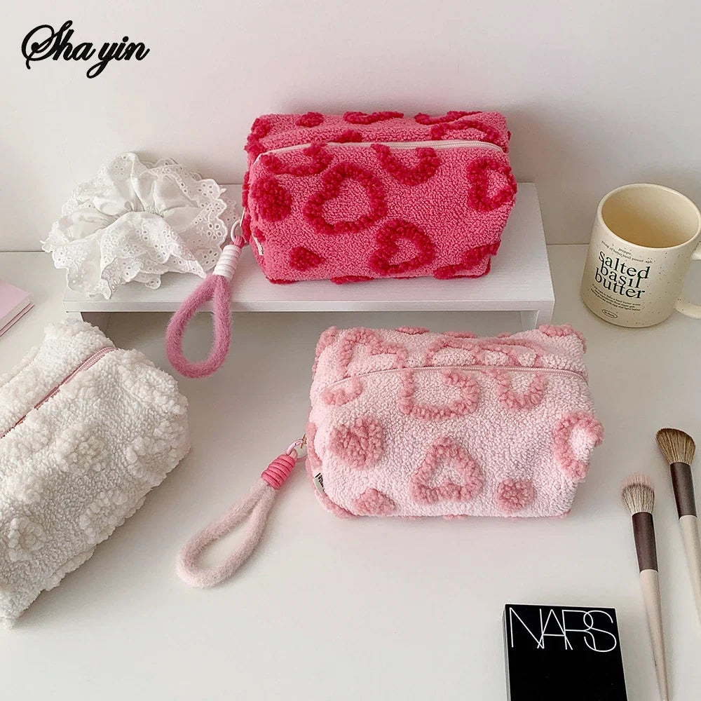 Soft plush makeup bag with handle by Blushimmer, featuring a cute love print for travel cosmetic storage and organization.
