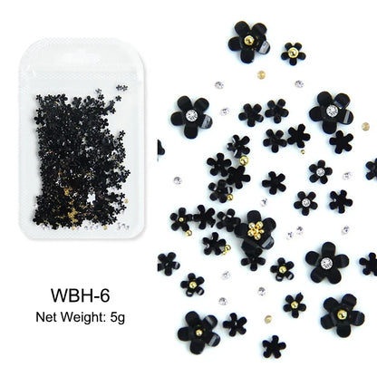 White acrylic flower nail art decorations with mixed size rhinestones, red and blue gems for DIY manicure design by Blushimmer