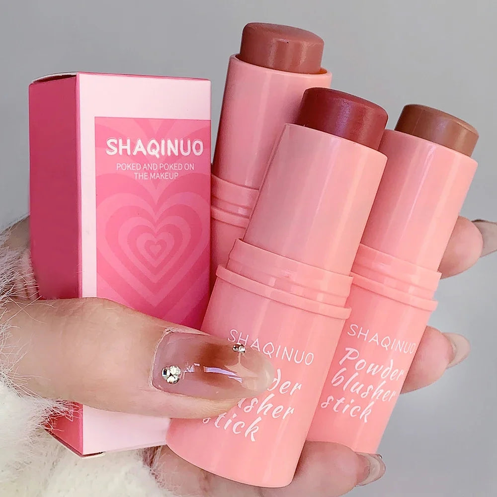 Blushimmer smooth blush stick in natural pink, long-lasting waterproof formula applied on cheek, brightening skin tone.