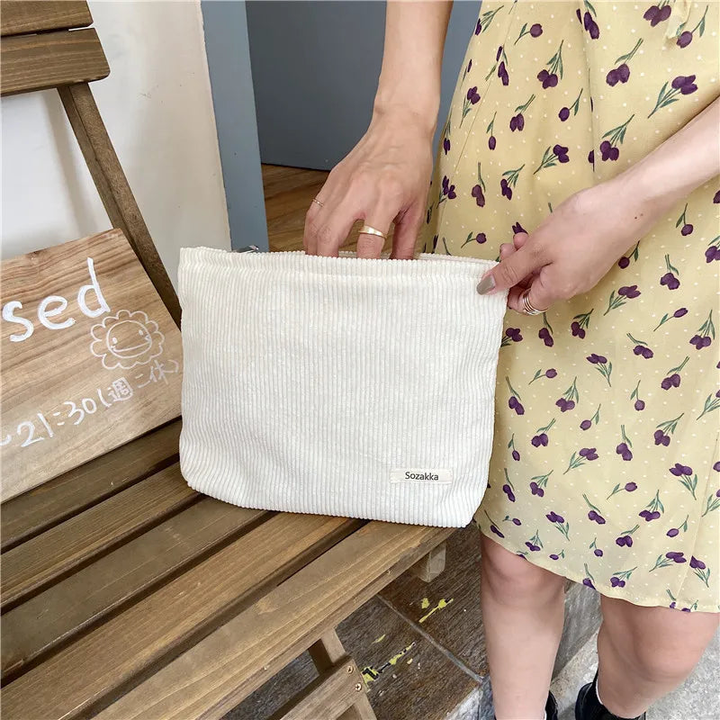 Blushimmer corduroy makeup bag for women, large capacity with lipstick, mobile phone, and change compartments in a handheld design.