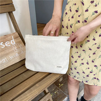 Blushimmer corduroy makeup bag for women, large capacity with lipstick, mobile phone, and change compartments in a handheld design.