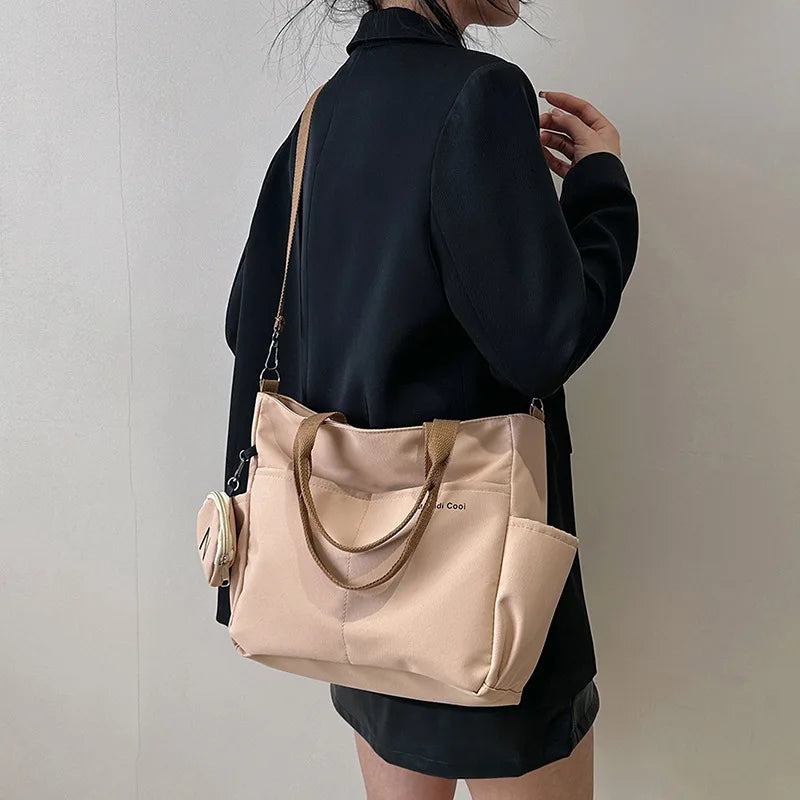 OBA women's khaki Oxford tote crossbody shoulder handbag with adjustable strap and structured design.