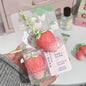 Shiji Strawberry temperature-changing lip balm by Blushimmer showing a sleek tube with a strawberry design, highlighting hydration and softness.