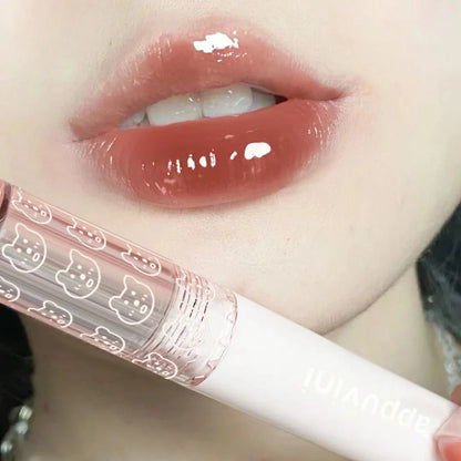 Cherry Pink Mirror Water Lip Gloss by Blushimmer, moisturizing glass lip oil with a shiny pink hue, displayed in a clear applicator.