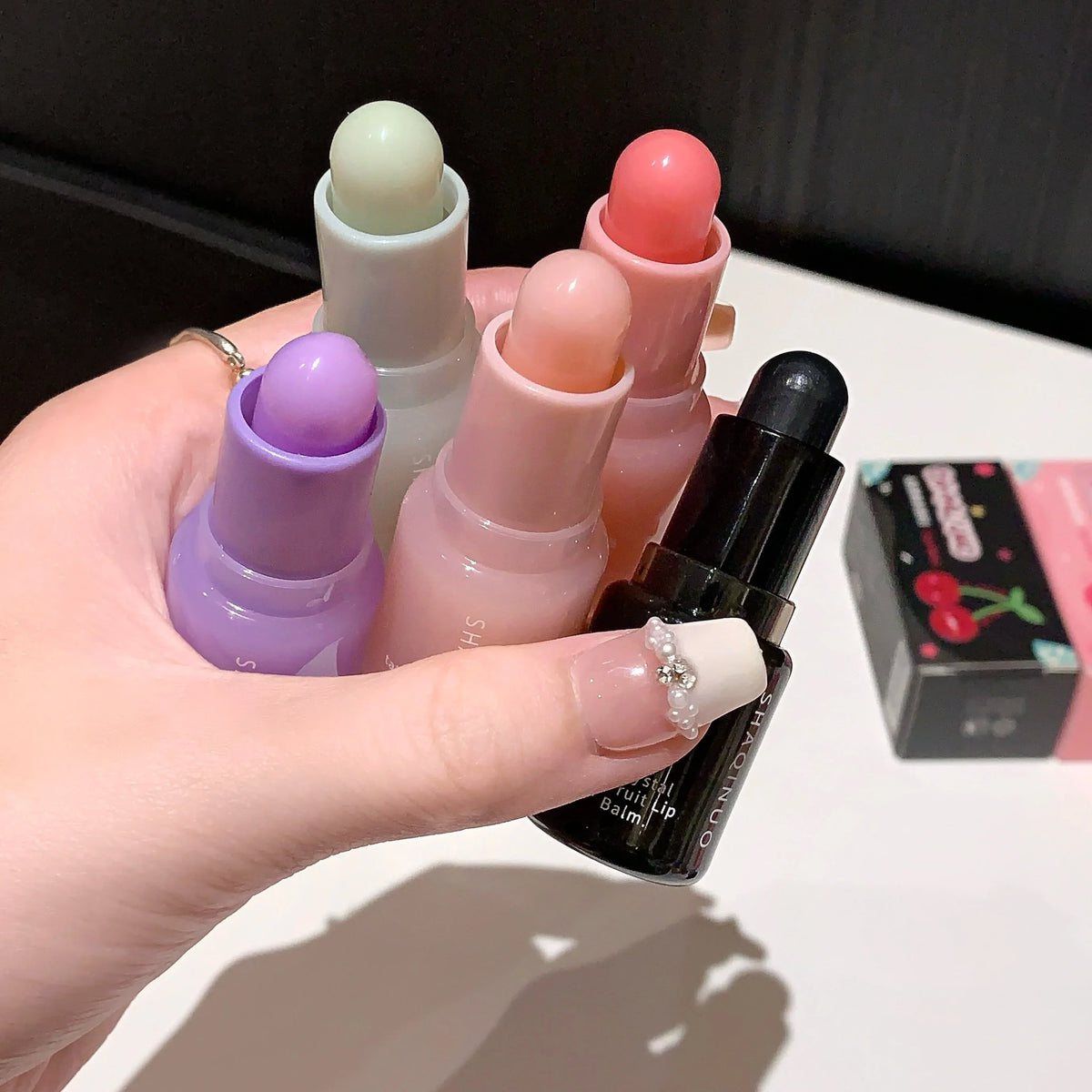Blushimmer hydrating fruit lip balm pendant with tinted moisturizing formula for dry lips, featuring refreshing fruit flavor.