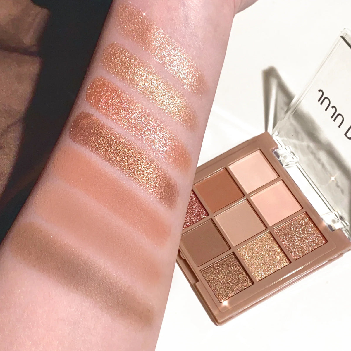 Blushimmer 9-18 color eyeshadow palette with velvet matte and shimmer finishes in berry, brown, and nude tones.