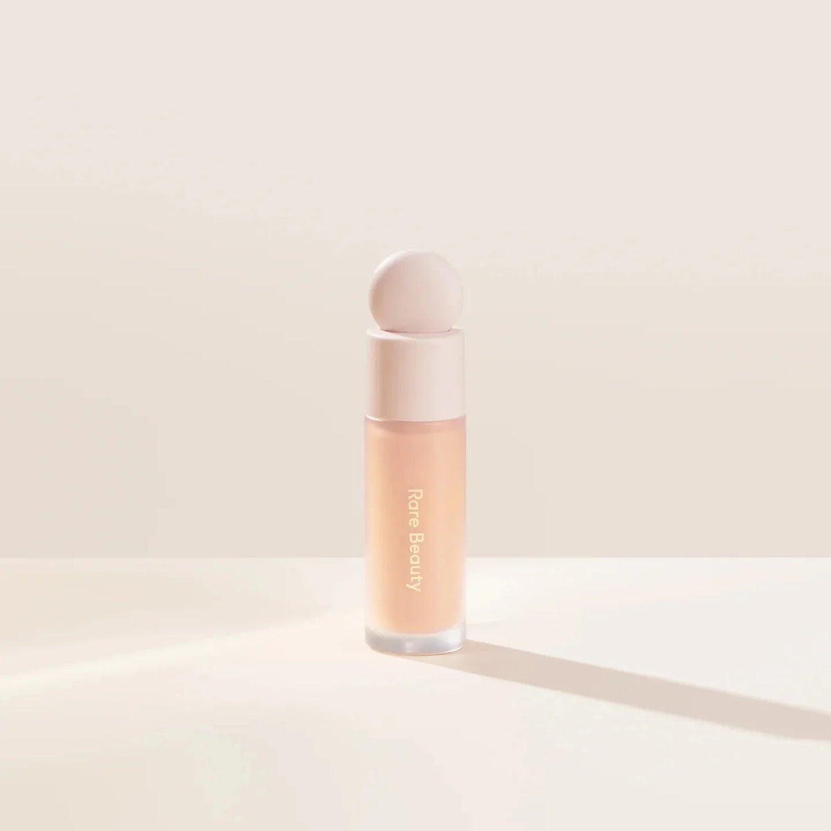 Blushimmer Rare Beauty liquid contour and highlighter in a sleek bottle, featuring a shimmering face blush and luminous glow.