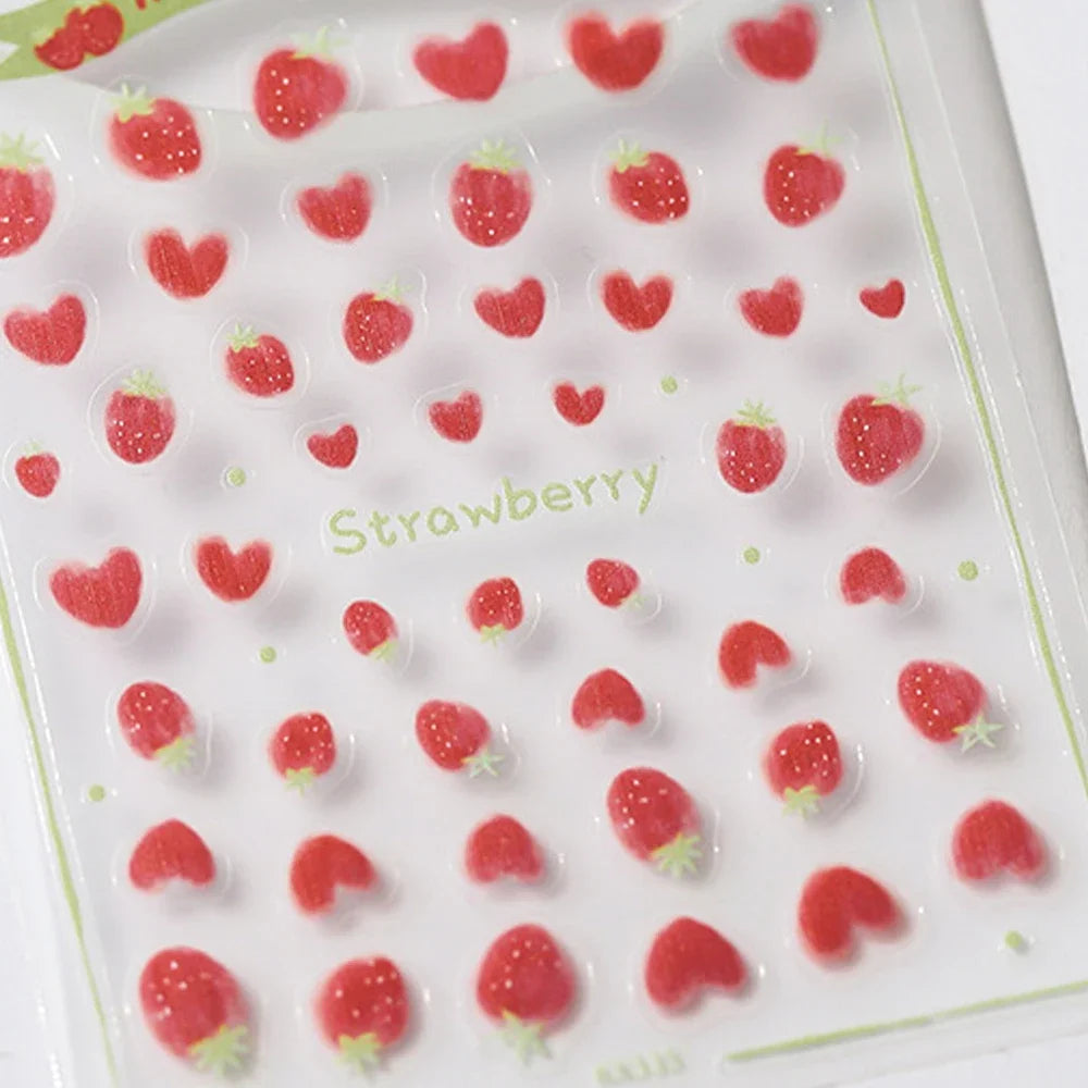 Close-up of shiny red cherry bowknot 5D nail art stickers with crystal rhinestones, perfect for DIY manicure decoration by Blushimmer.