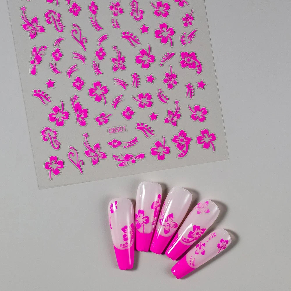 White and black 3D hibiscus floral nail stickers by Blushimmer, featuring pink and gold accents for nail art decoration.