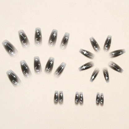 Set of 24 Blushimmer Y2k star press on nails featuring gradient black color, moon designs, and mid-length coffin shape.