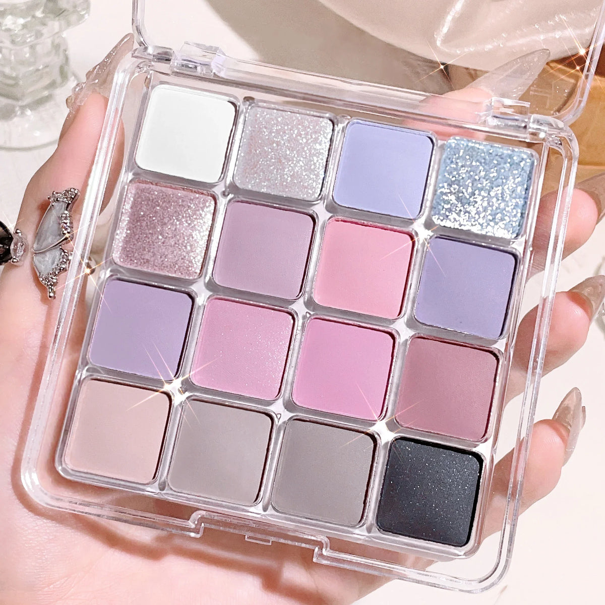 Sixteen-color sunset magic eye shadow palette by Blushimmer featuring pearl and matte earth tones for Korean makeup looks.