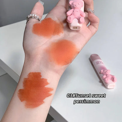 Blushimmer Cute Little Bear Lip Glaze Matte Velvet Lipstick with whitening lip cream and colorful lip color, held in hand.