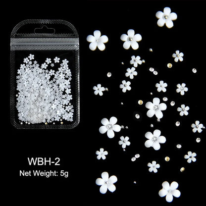 White acrylic flower nail art decorations with mixed size red and blue rhinestones for DIY manicure designs by Blushimmer