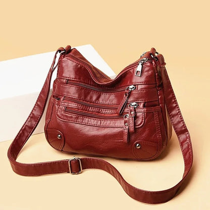 Red women's multi-layer leather shoulder crossbody bag by OBA, featuring multiple tiers and a sleek design.