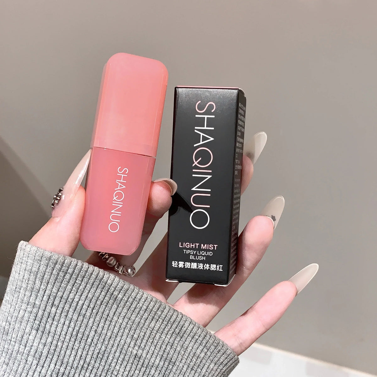 Blushimmer Light Blush Liquid Rouge in natural pink shade with moisturizing and brightening effects, displayed in a sleek bottle.