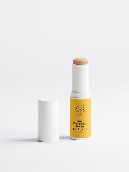 Tinted SPF50 mineral sunscreen stick by BelleVie Cosmétiques with zinc oxide and titanium dioxide, showing the portable 12g sun protection product.
