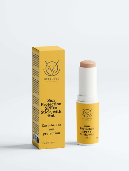 Tinted SPF50 mineral sunscreen stick by BelleVie Cosmétiques with zinc oxide and titanium dioxide, showing the compact tube and applicator.
