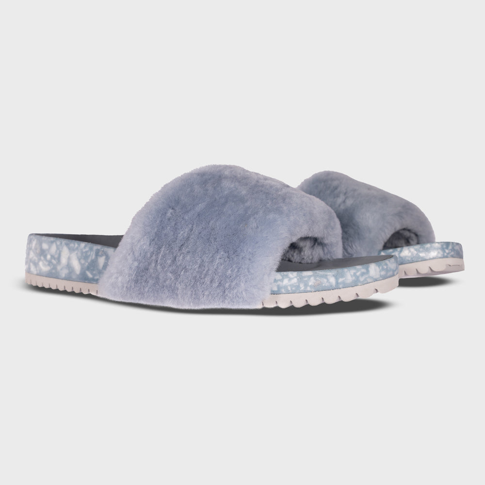 Pair of Fleks San Ysidro Slide sandals in fog color, showing the stylish design from a side angle.