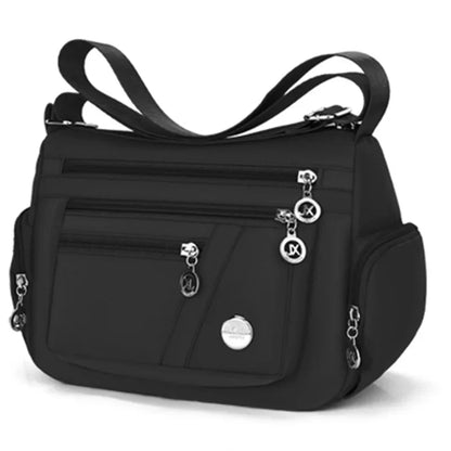 Black OBA ladies crossbody travel handbag with adjustable strap and spacious interior, perfect for everyday use and travel.