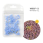 White acrylic flower nail art decorations with mixed size rhinestones in red and blue for DIY manicure designs, by Blushimmer.