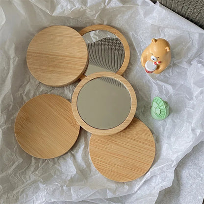 Blushimmer portable round cosmetic mirror made of pure wood, compact design ideal for travel and beauty touch-ups.