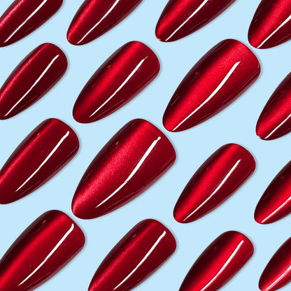 Set of 24 glossy red cat's eye press-on nails with nude almond shape by Blushimmer, featuring detachable charms for a stylish look.
