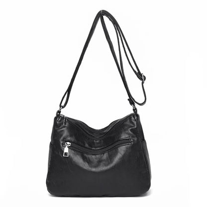 Black women's multi-layer leather shoulder crossbody bag by OBA with multiple compartments and adjustable strap.