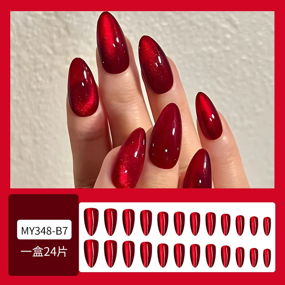 Set of 24 glossy red cat's eye press on nails by Blushimmer, almond-shaped, full cover false nails with nude color and detachable charms.