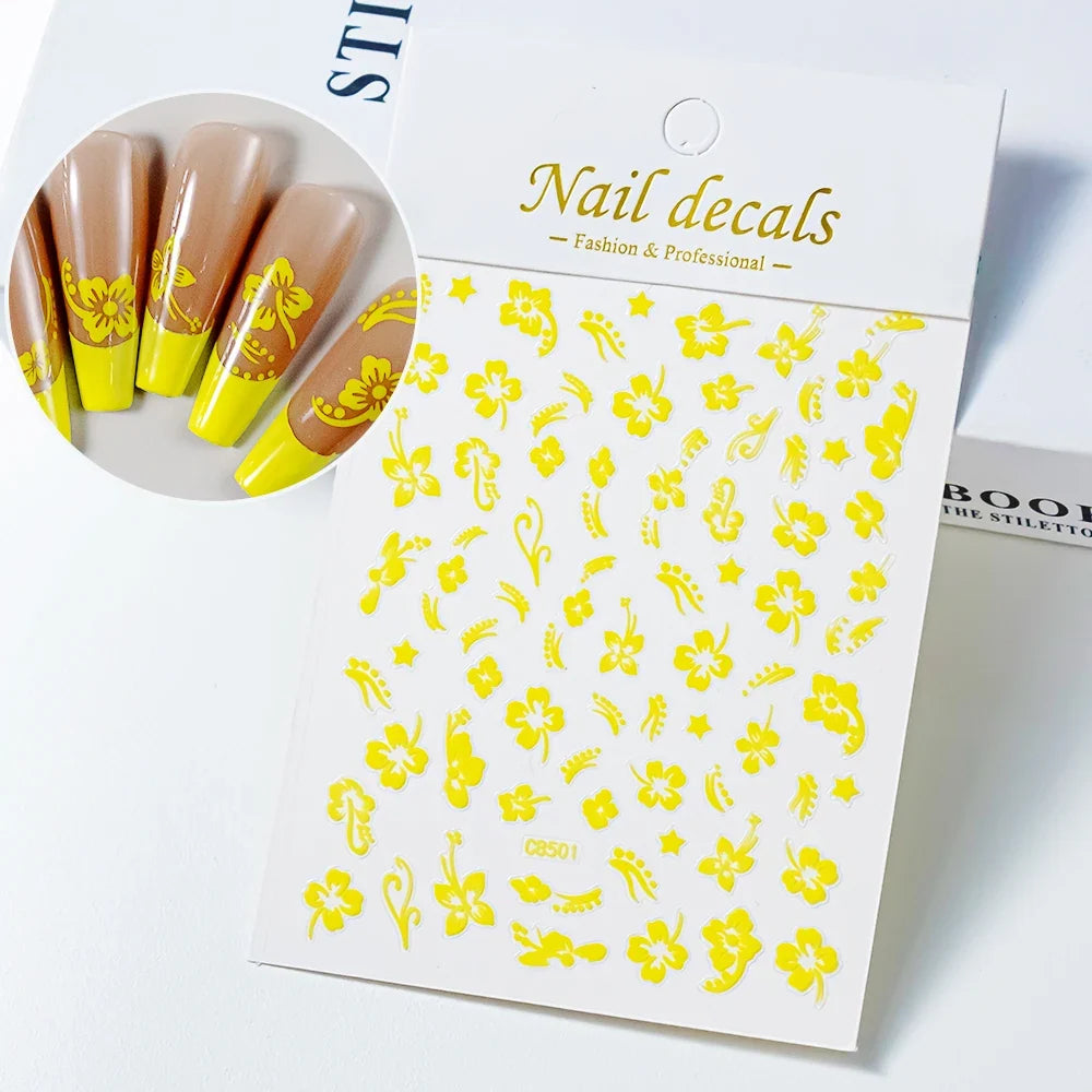 White and black 3D hibiscus flower nail stickers with pink and gold accents, adhesive floral decals for nail art decoration.
