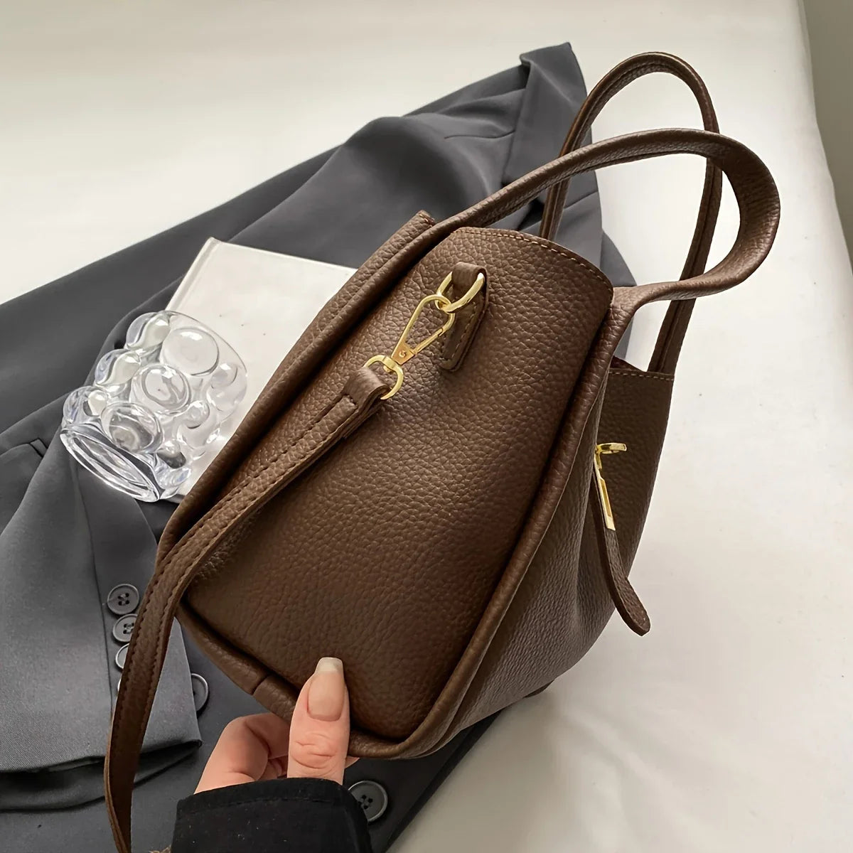 NNEOBA women's multifunctional crossbody handbag with adjustable strap, sleek design, and multiple compartments for accessories.