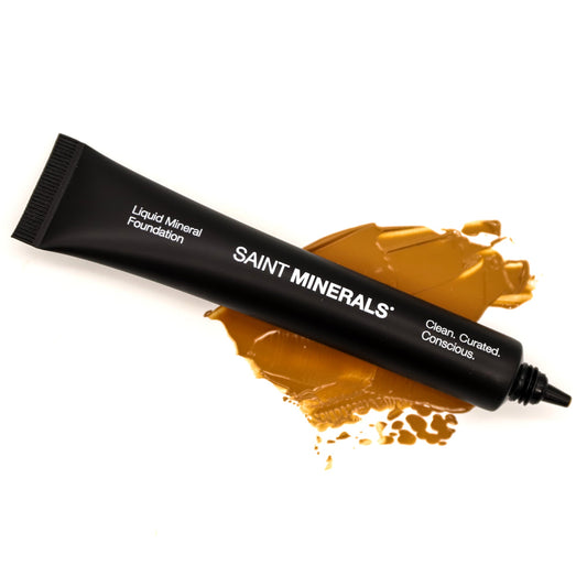 Panoply Beauty Saint Minerals Liquid Foundation bottle with a sleek, minimalist design and a light beige shade in the image.