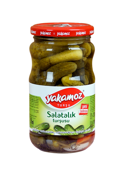 Glass jar of Yakamoz cucumber pickles from S101, filled with crunchy, sliced cucumber pickles in brine.