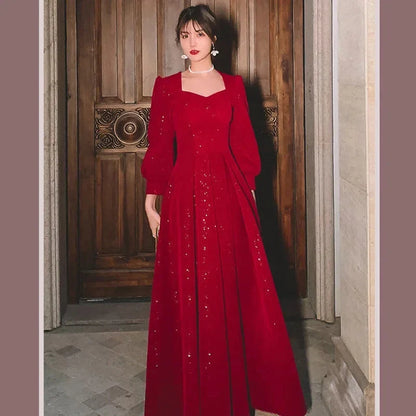 Elegant red luxury ceremony gown by Luxlife Brands, featuring flowing fabric and intricate detailing for formal events.